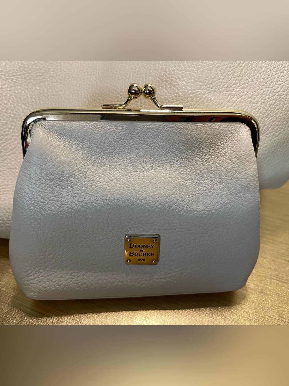 Dooney & Bourke Cream Leather Kiss-Lock Frame Clutch with Gold Plaque